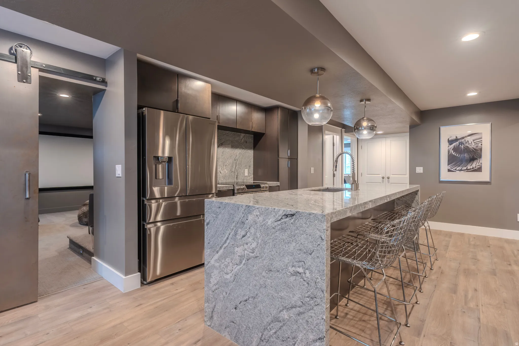 Kitchen island featuring a waterfall countertop