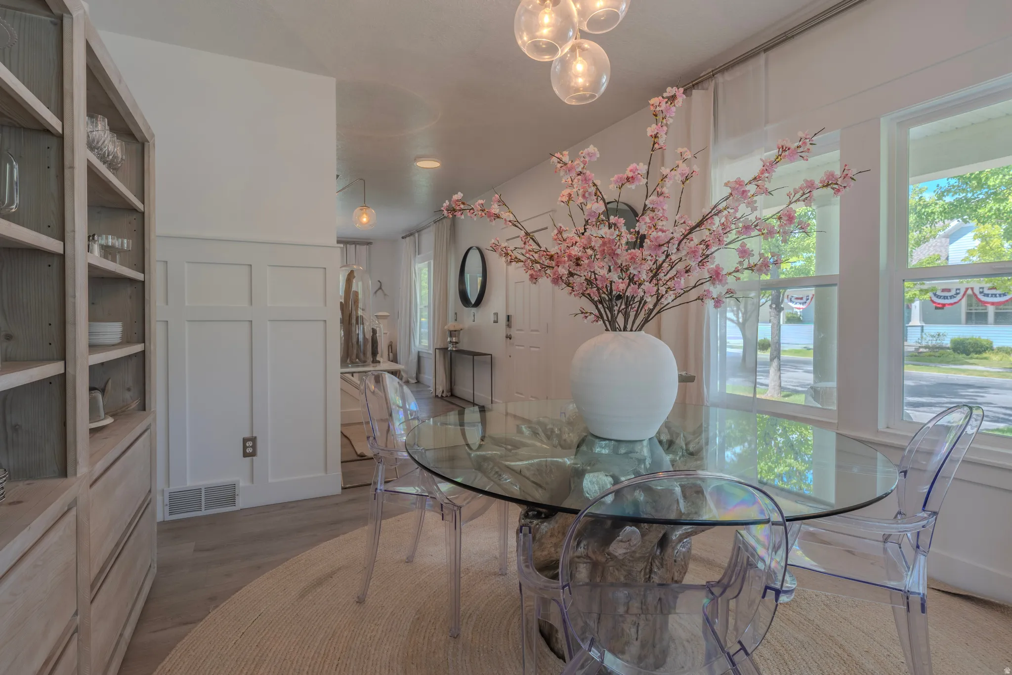Recessed lighting, wood-finish flooring, and white board and batten wall paneling