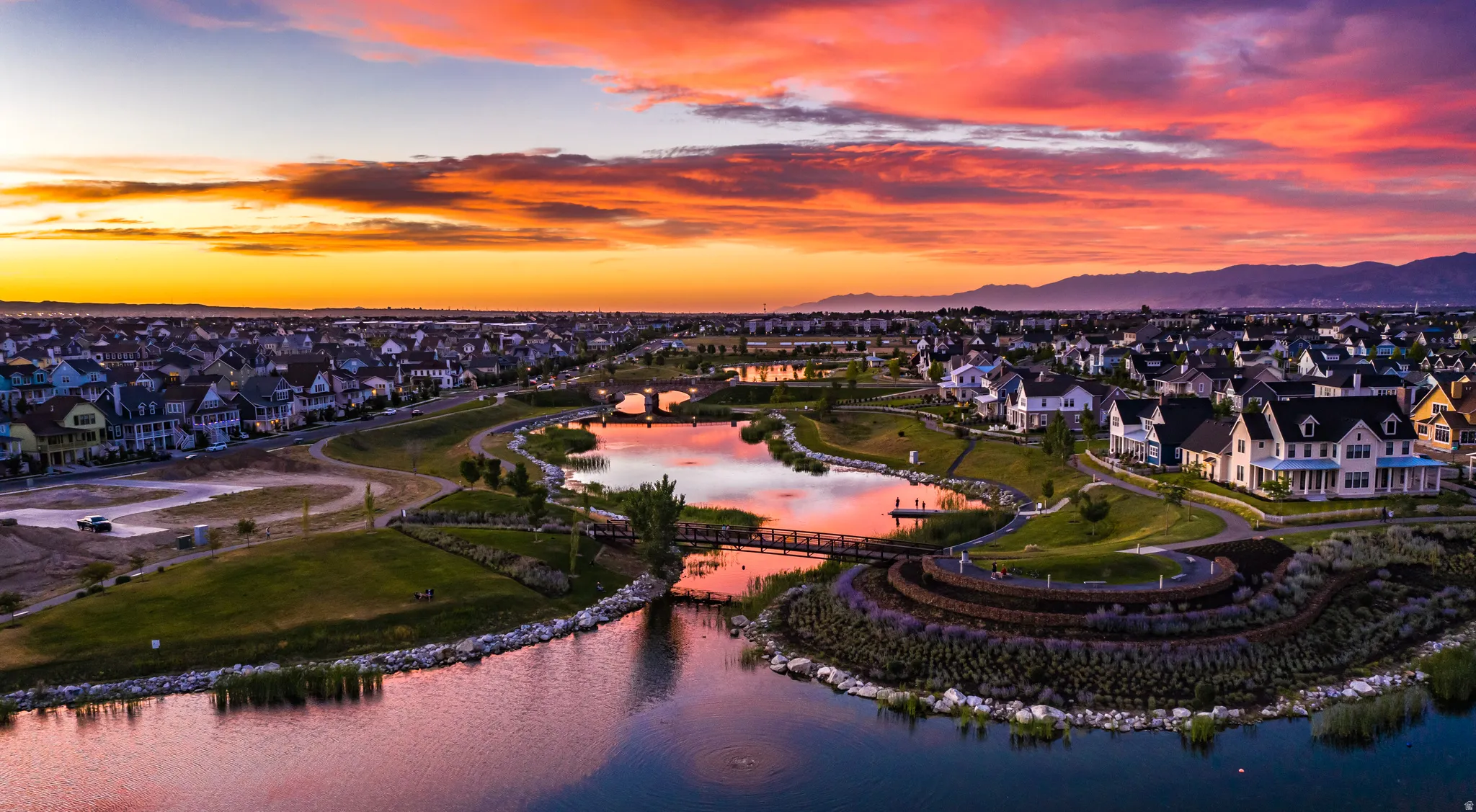 Expansive residential community featuring multiple water elements, pedestrian bridges, and structured landscaping