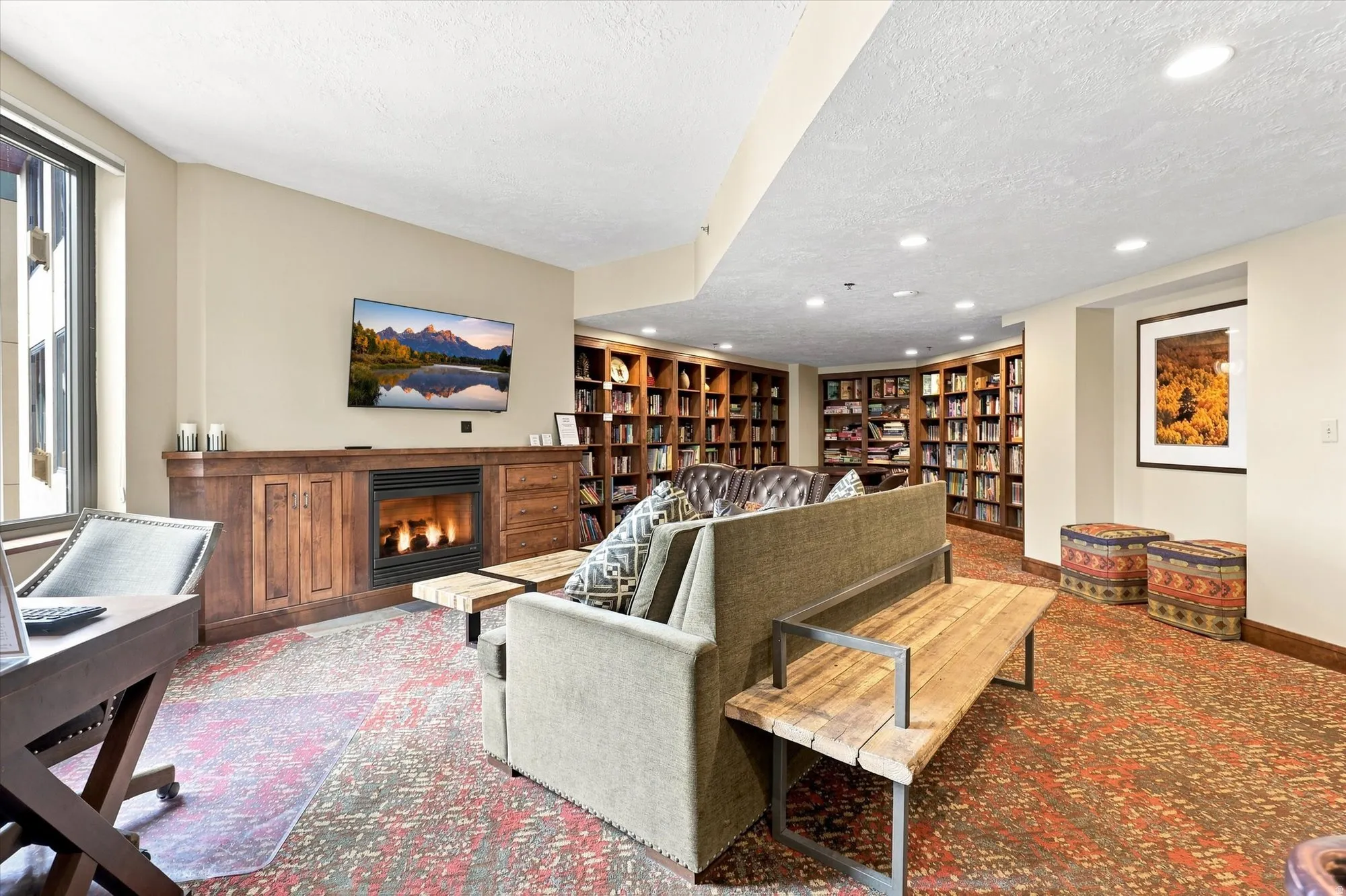 Built-in wood cabinetry with a fireplace, recessed lighting, and extensive wall-mounted bookshelves