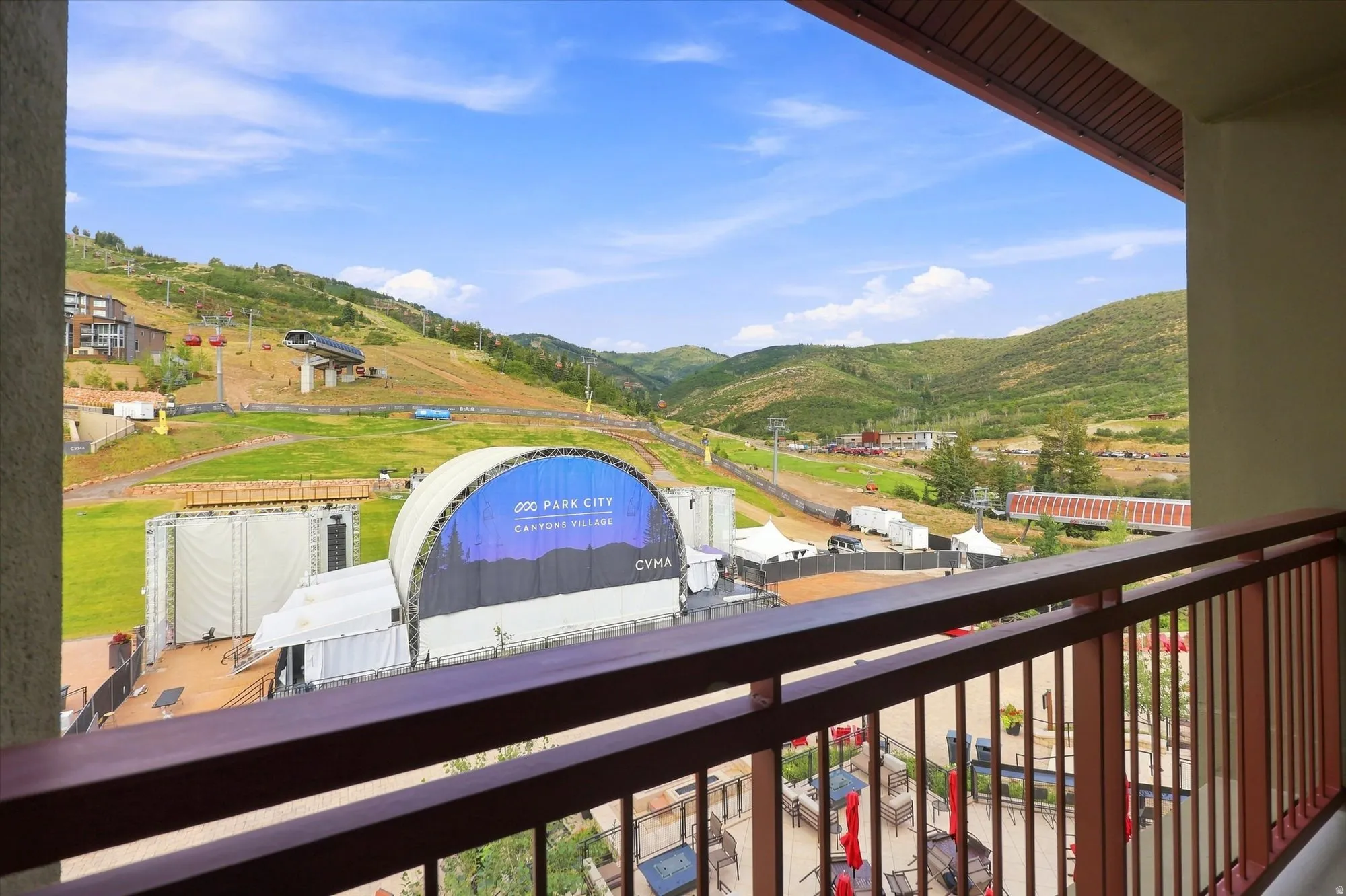 Balcony with metal railing providing expansive scenery of surrounding hills