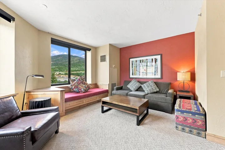 Built-in window bench seating with a mountain backdrop, complemented by an accent wall and recessed lighting