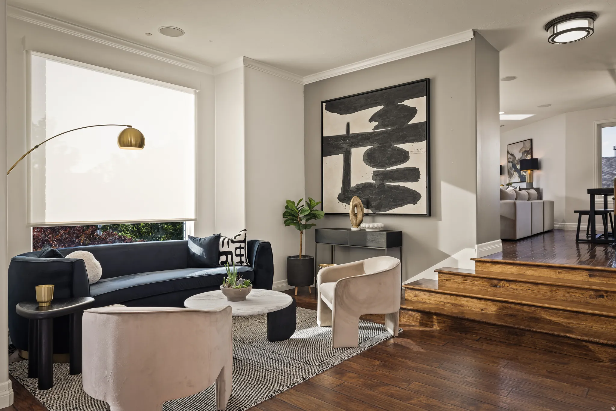 Hardwood flooring, recessed ceiling lighting, crown molding, and a built-in speaker system