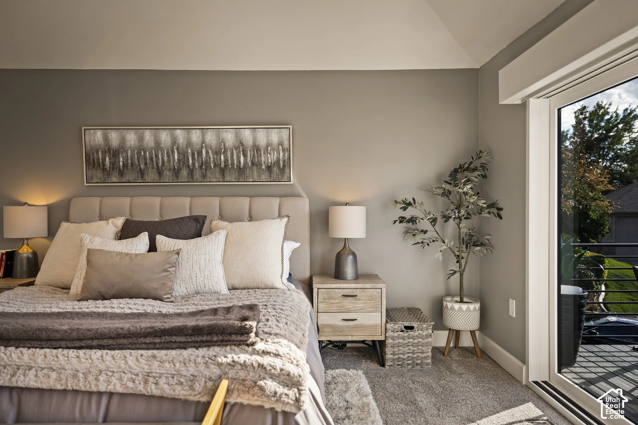 Plush carpeting, neutral wall colors, and a sliding glass door providing exterior access