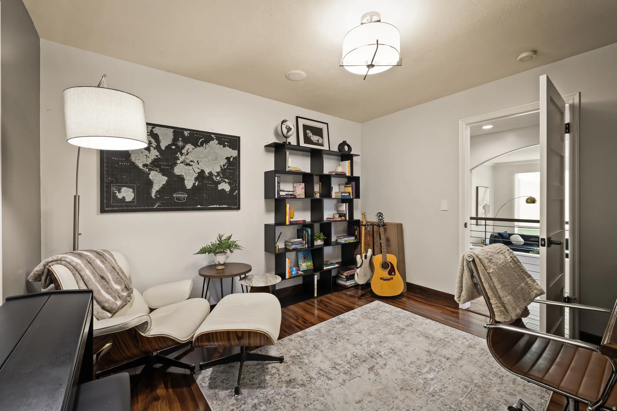 Hardwood-finish flooring, built-in shelving, recessed lighting, and a paneled interior door