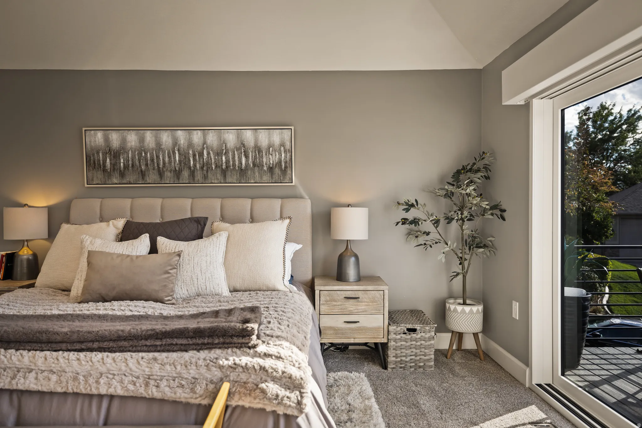 Plush carpeting, neutral wall colors, and a sliding glass door providing exterior access