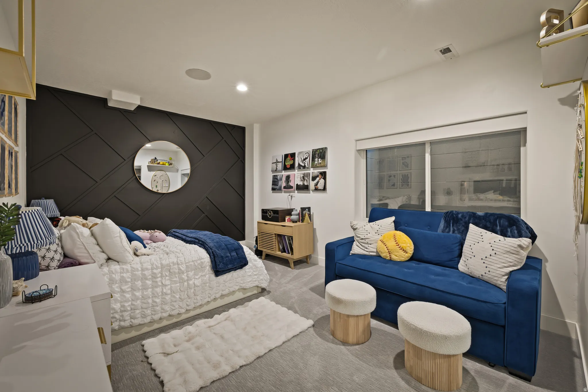 Accent wall with geometric paneling, recessed lighting, and a neutral carpet