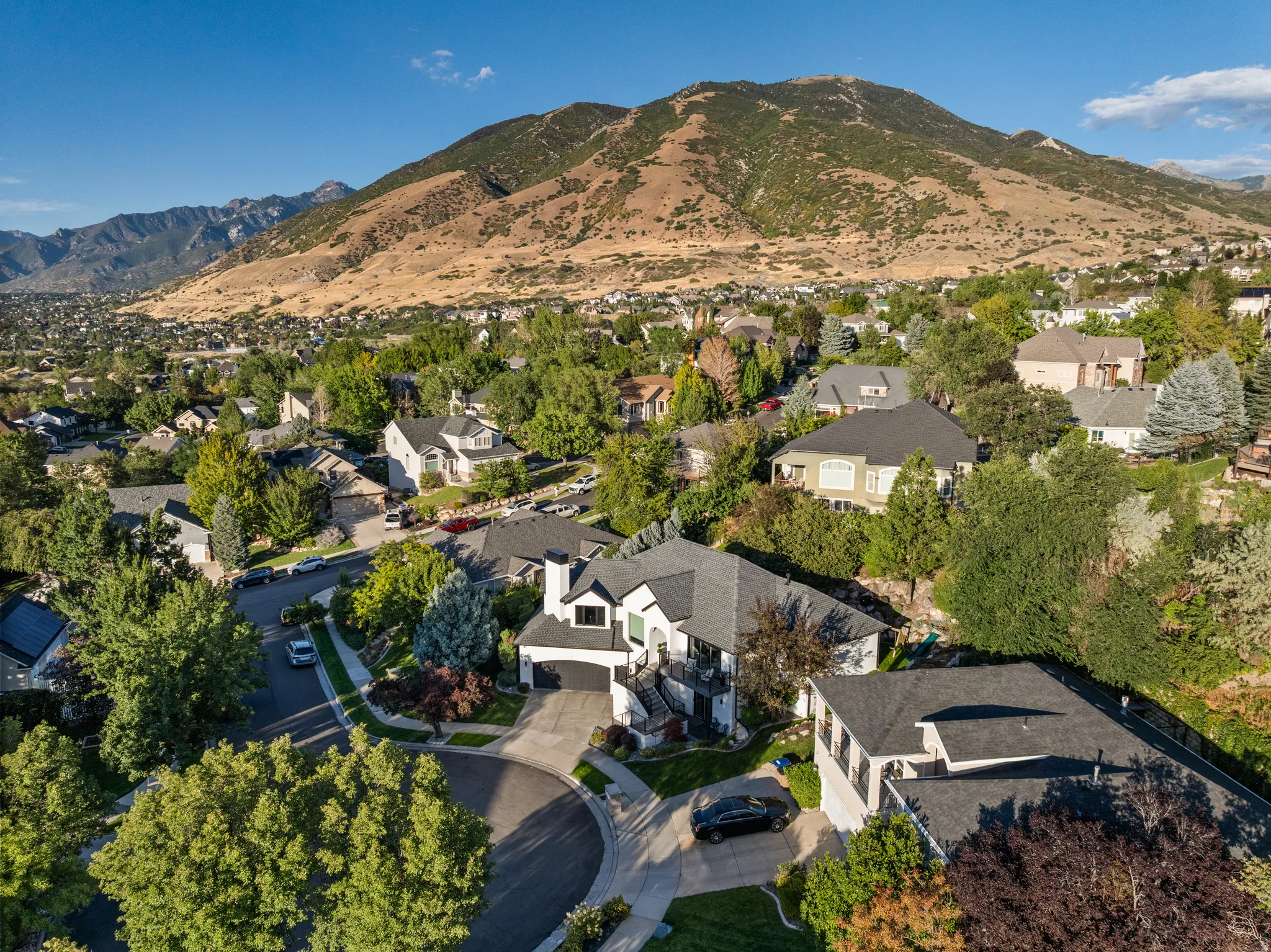 Neighborhood setting featuring mature trees and a cul-de-sac