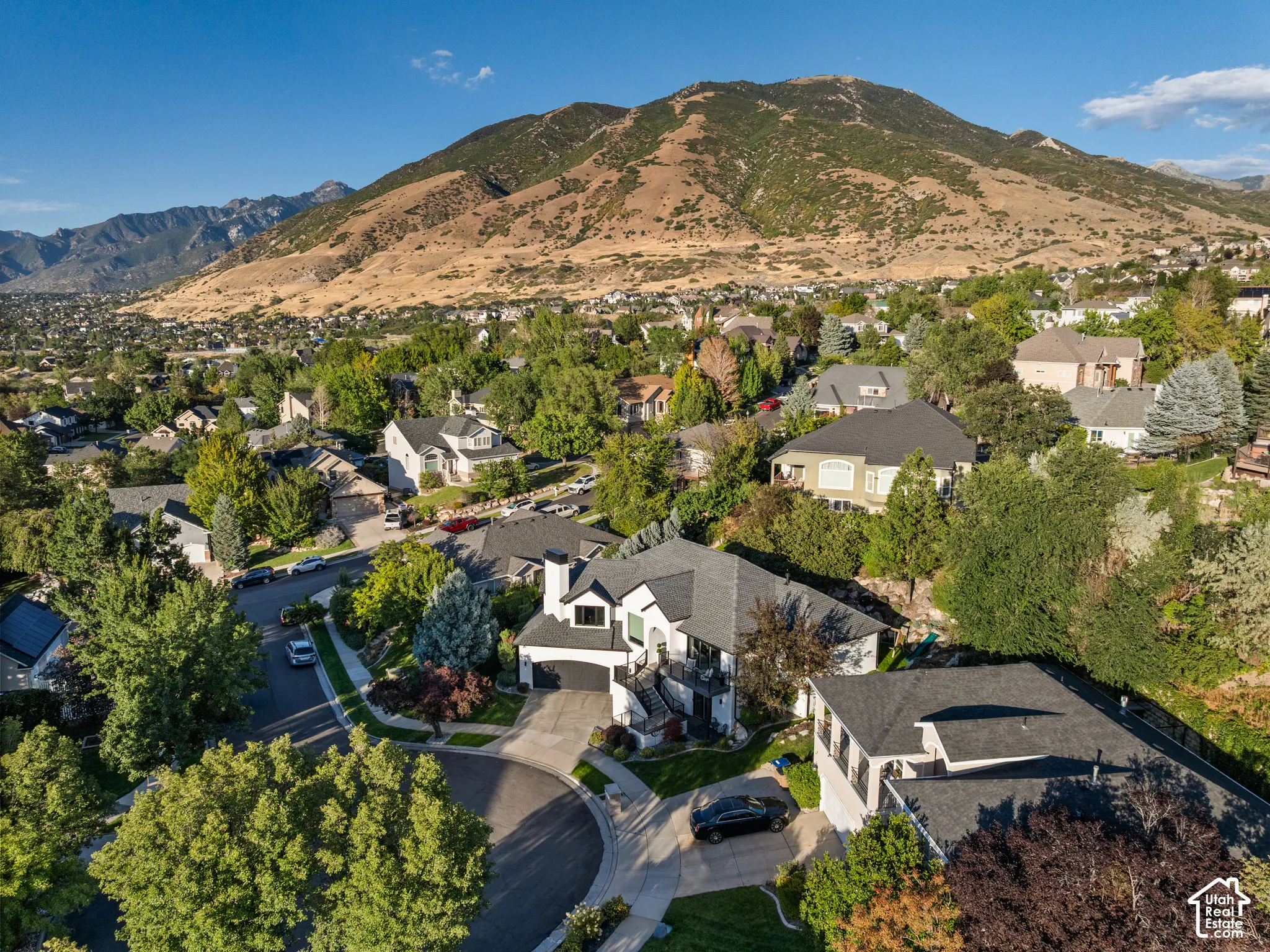 Neighborhood setting featuring mature trees and a cul-de-sac
