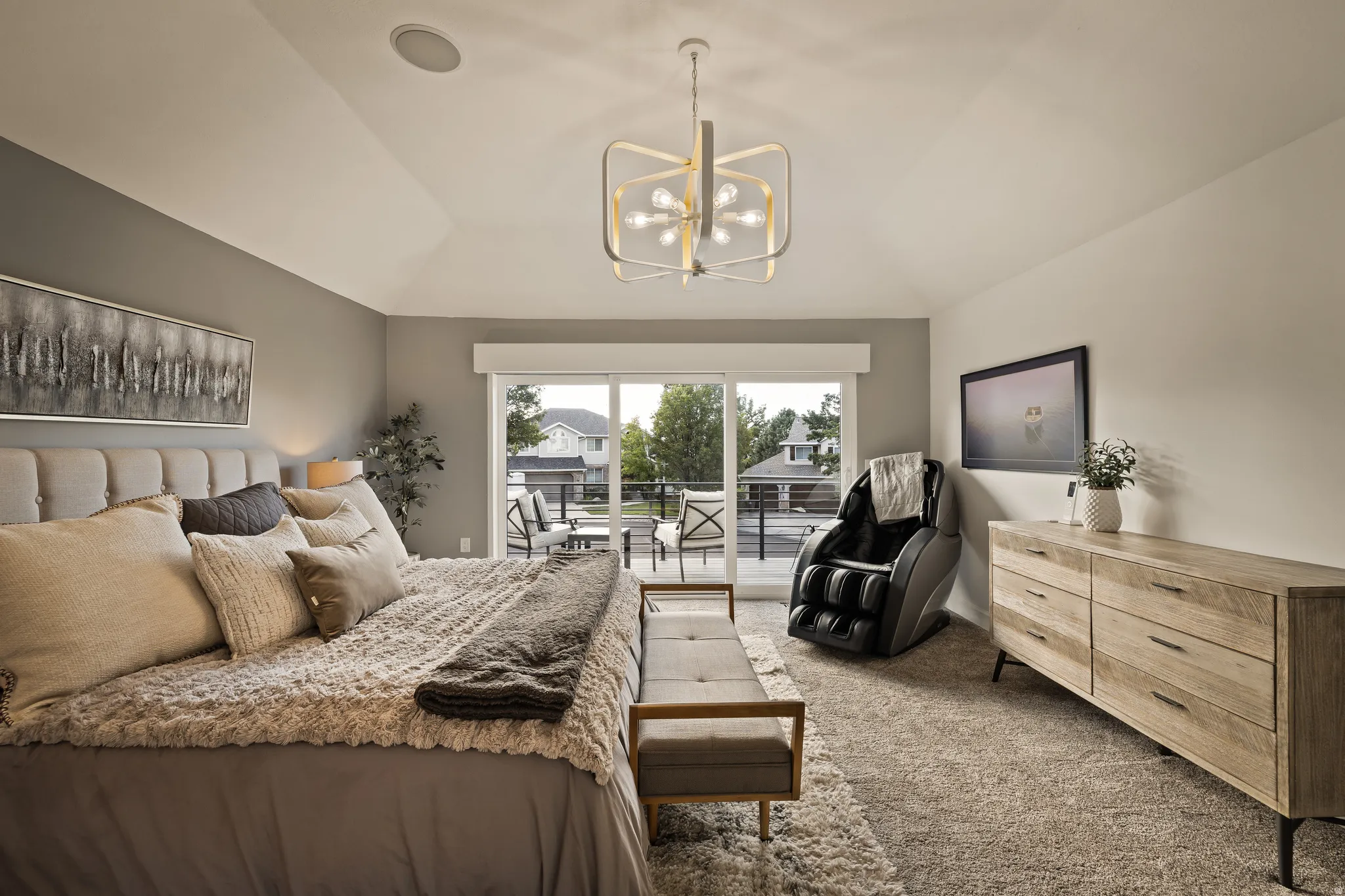 Vaulted ceiling with an overhead light fixture, recessed lighting, and sliding glass door leading to an outdoor deck