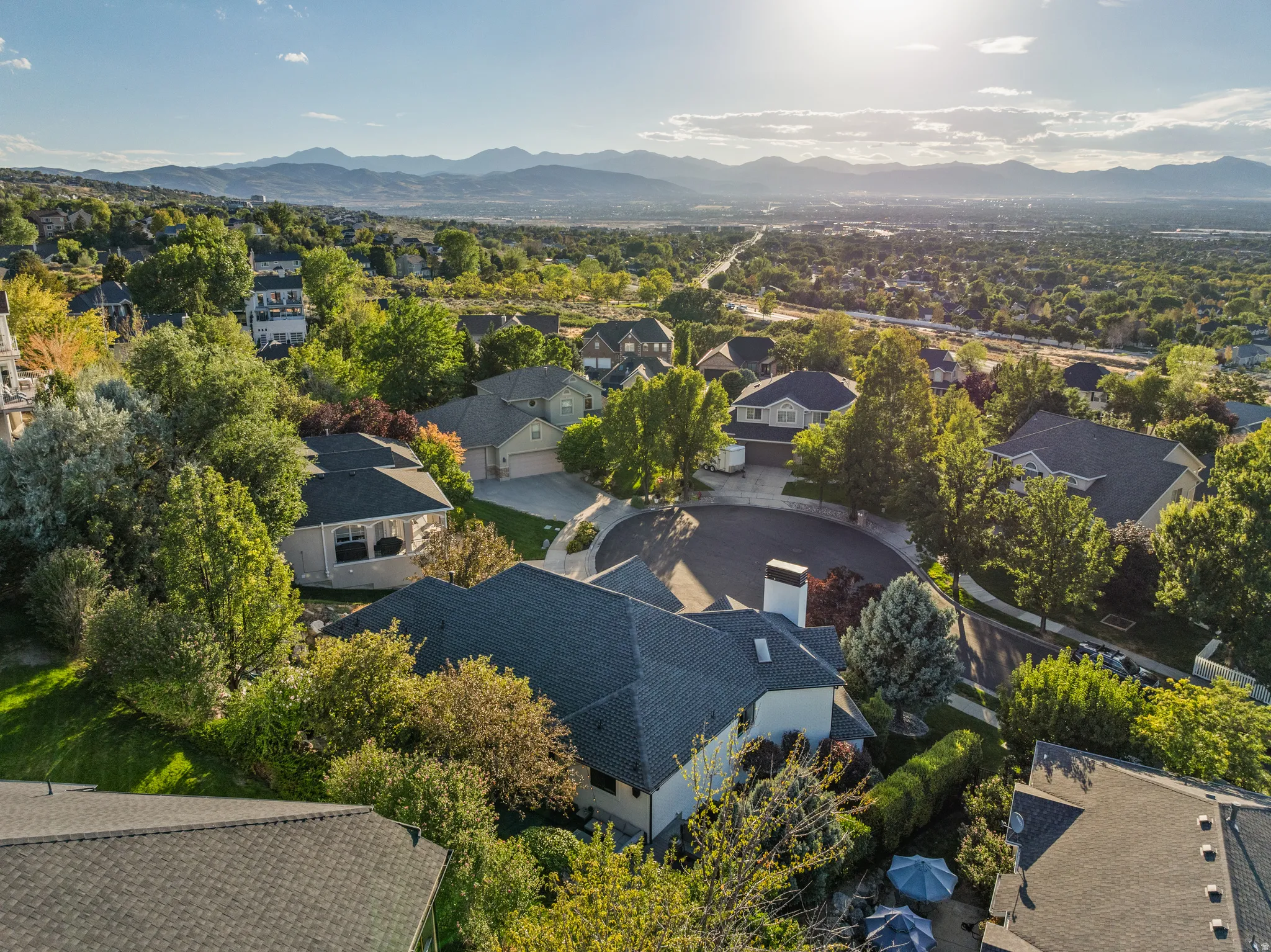 Established neighborhood featuring cul-de-sac streets, mature trees, and mountain scenery