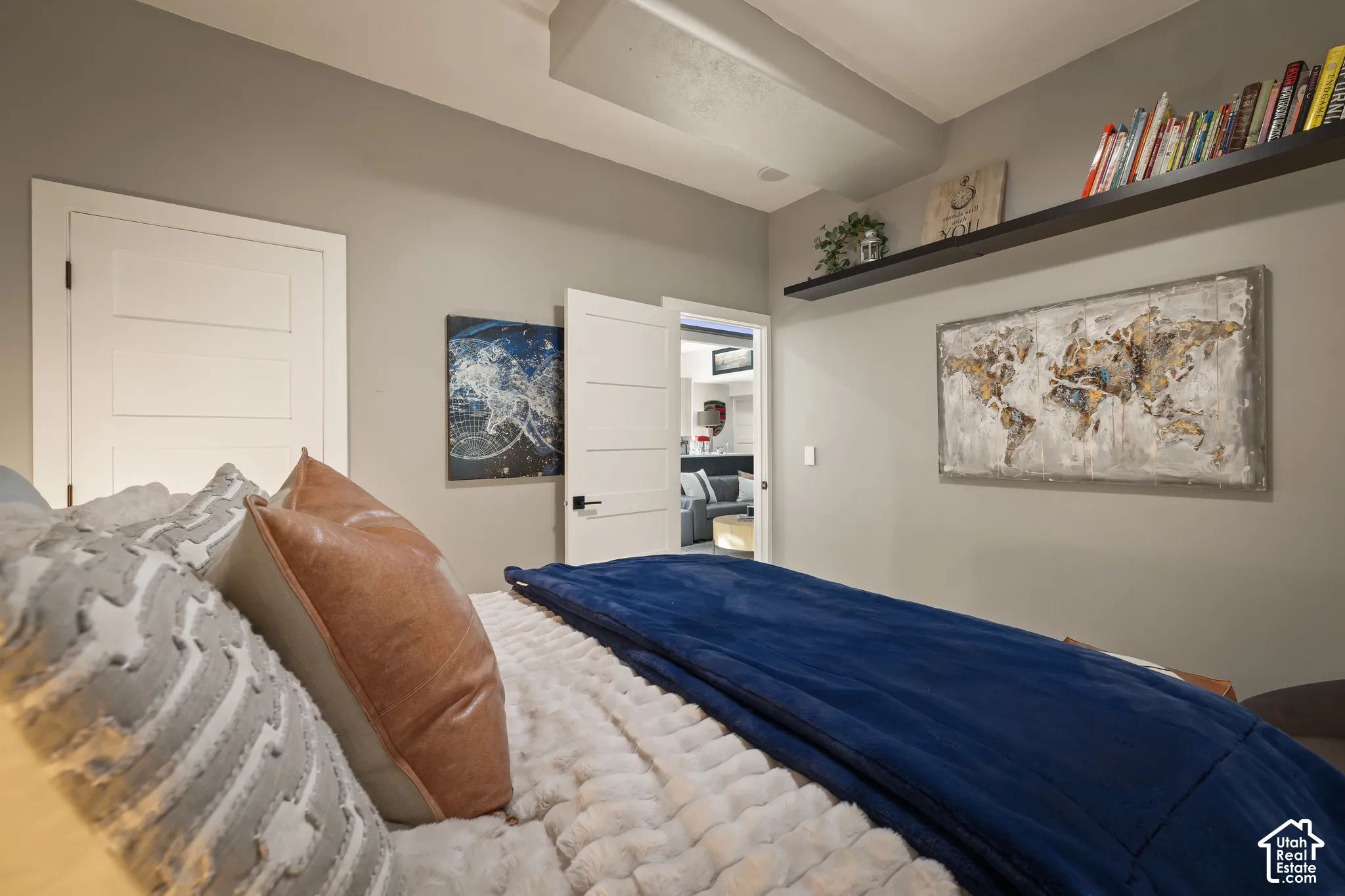 Recessed ceiling beam with flush-mounted lighting, white solid core doors, and a built-in wall shelf