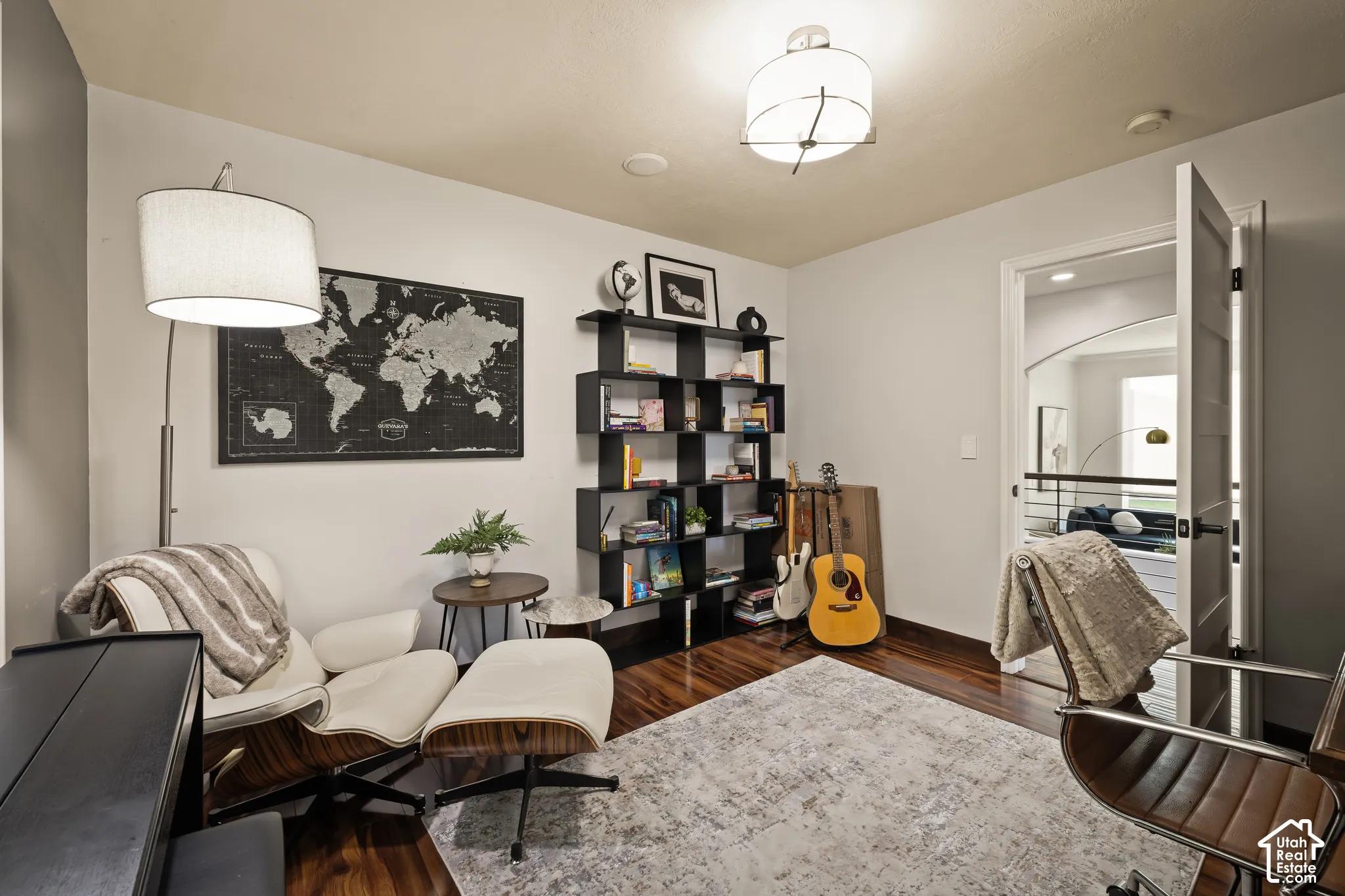 Hardwood-finish flooring, built-in shelving, recessed lighting, and a paneled interior door