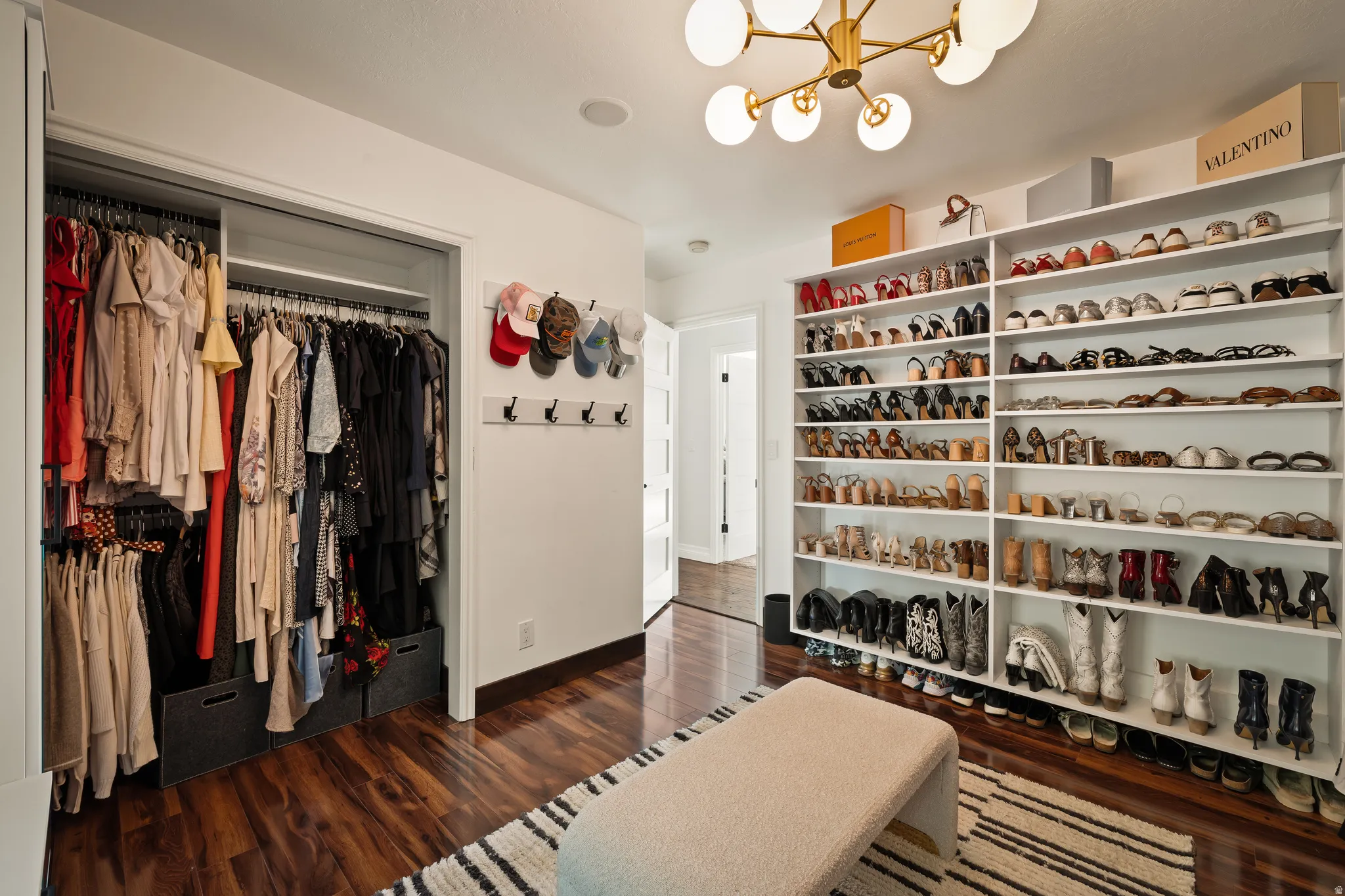 Recessed lighting, wood-finish flooring, built-in shelving, and a modern ceiling light fixture