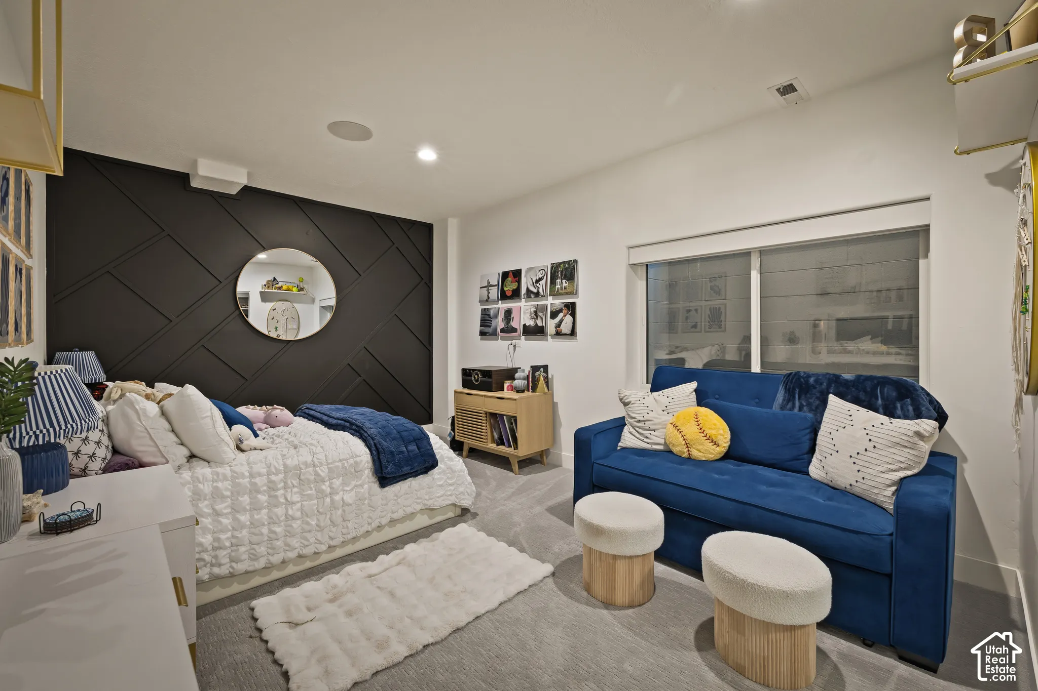 Accent wall with geometric paneling, recessed lighting, and a neutral carpet