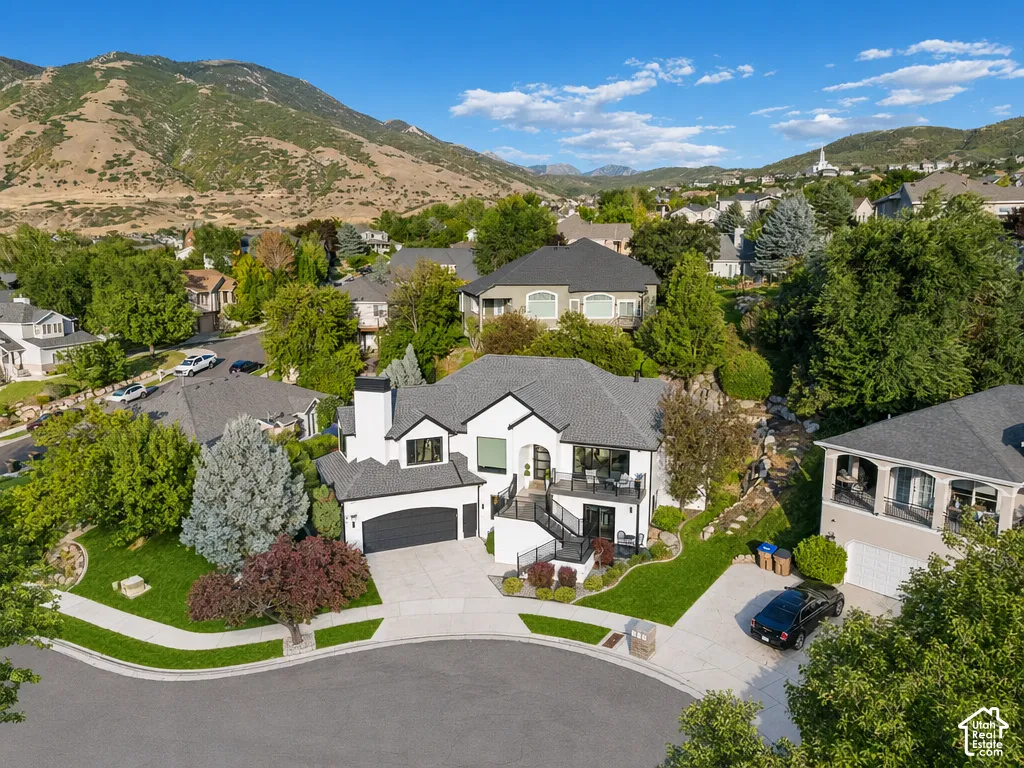 Modern two-story residence with a black and white exterior and attached garage
