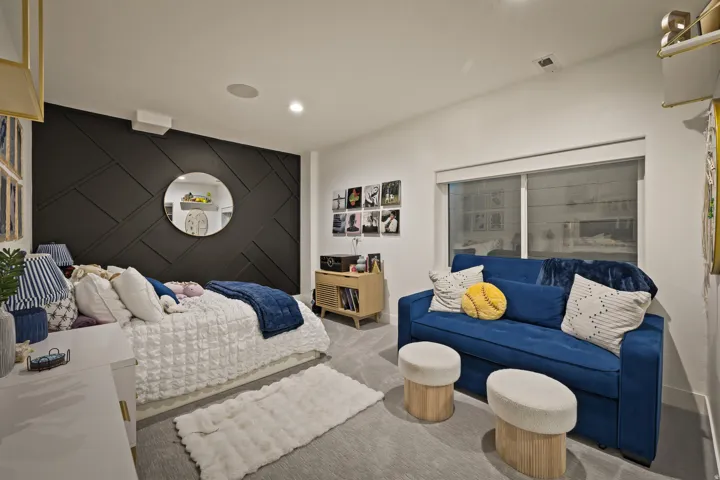 Accent wall with geometric paneling, recessed lighting, and a neutral carpet