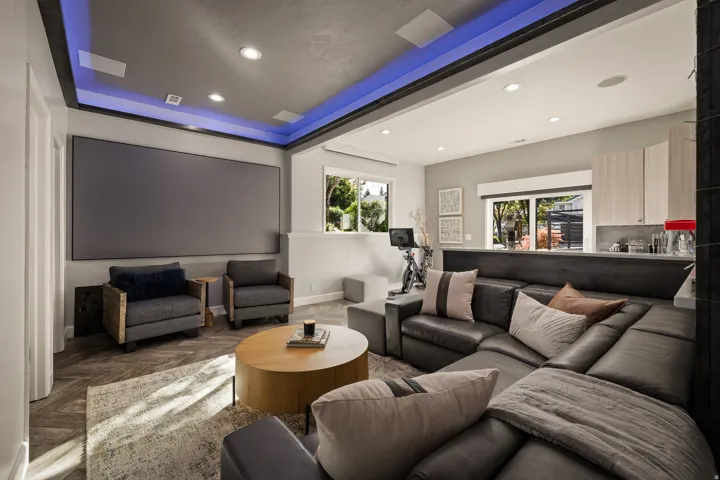Recessed lighting, wood-finish flooring, built-in display screen, and a built-in bar area with cabinetry