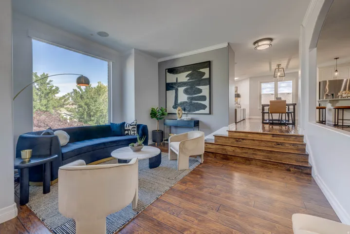 Hardwood flooring, expansive window, built-in ceiling speaker, arched doorway, and recessed lighting