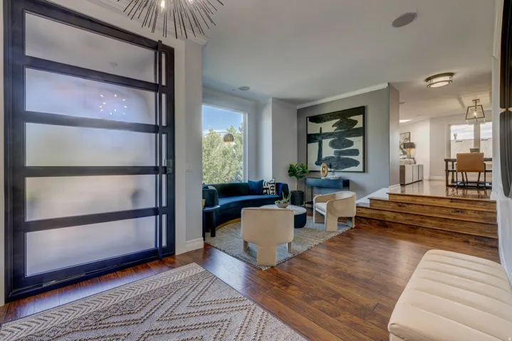 Entryway featuring a modern frosted glass door, wood-finish flooring, and recessed lighting