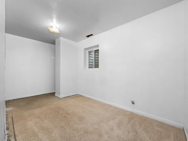 Recessed window, white painted walls, and light-colored carpeting