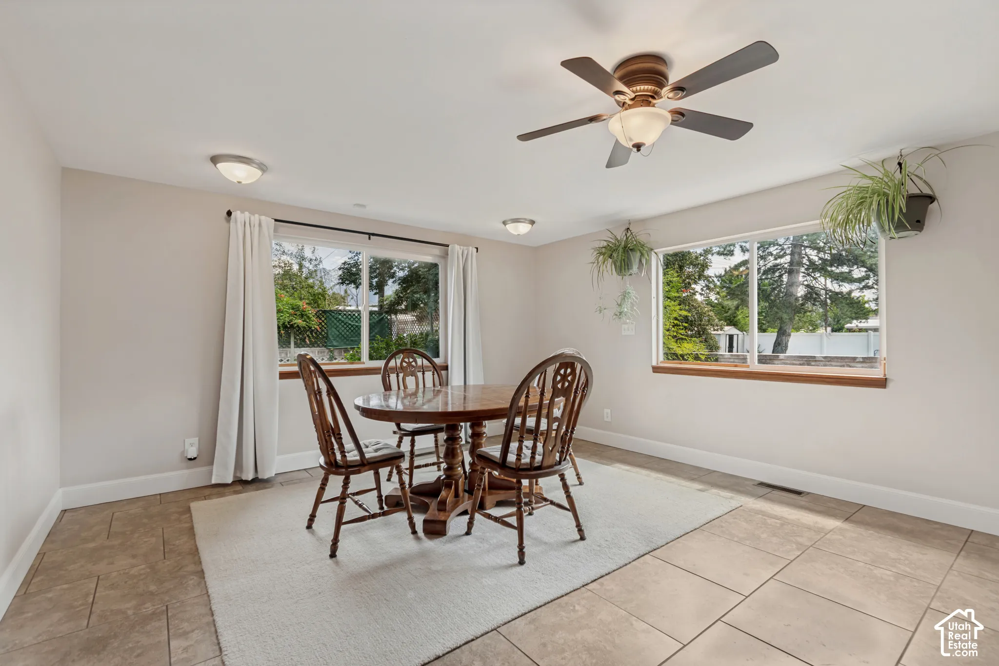 Recessed ceiling lights, ceiling fan with integrated lighting, wood-trimmed windows, and tile flooring. Crawl space under the dining area
