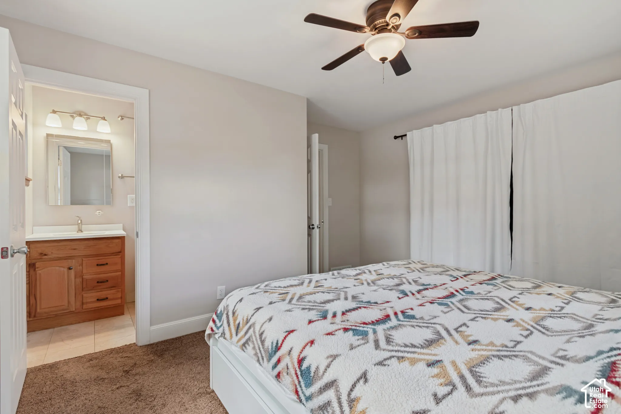 Warm-toned wall paint with a ceiling fan and plush carpet