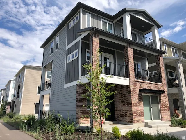 Multi-story facade featuring brick and siding accents
