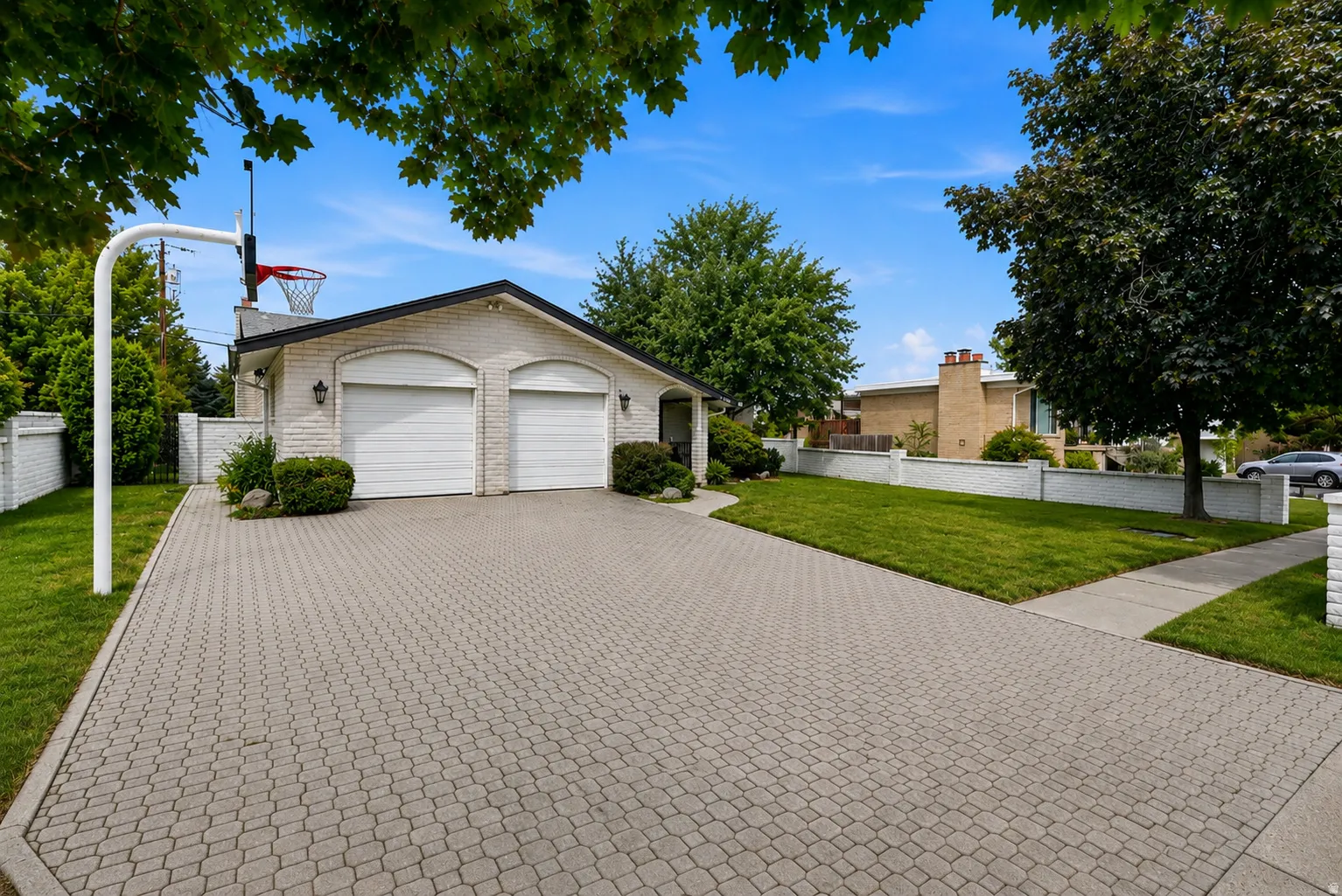 Brick exterior with a gabled roofline, featuring a two-car garage with arched entries