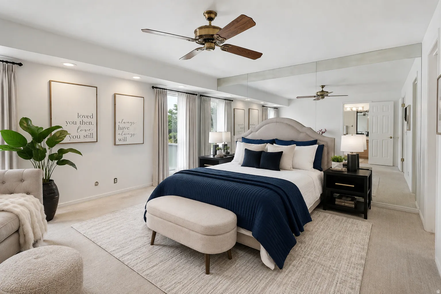 Recessed lighting, ceiling fan with light, upholstered bed frame, full-height wall mirrors, and double windows with curtain rods