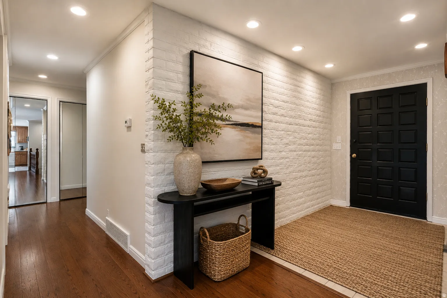 Entryway featuring brick-textured accent wall, recessed lighting, dark wood-finish flooring, and paneled entry door