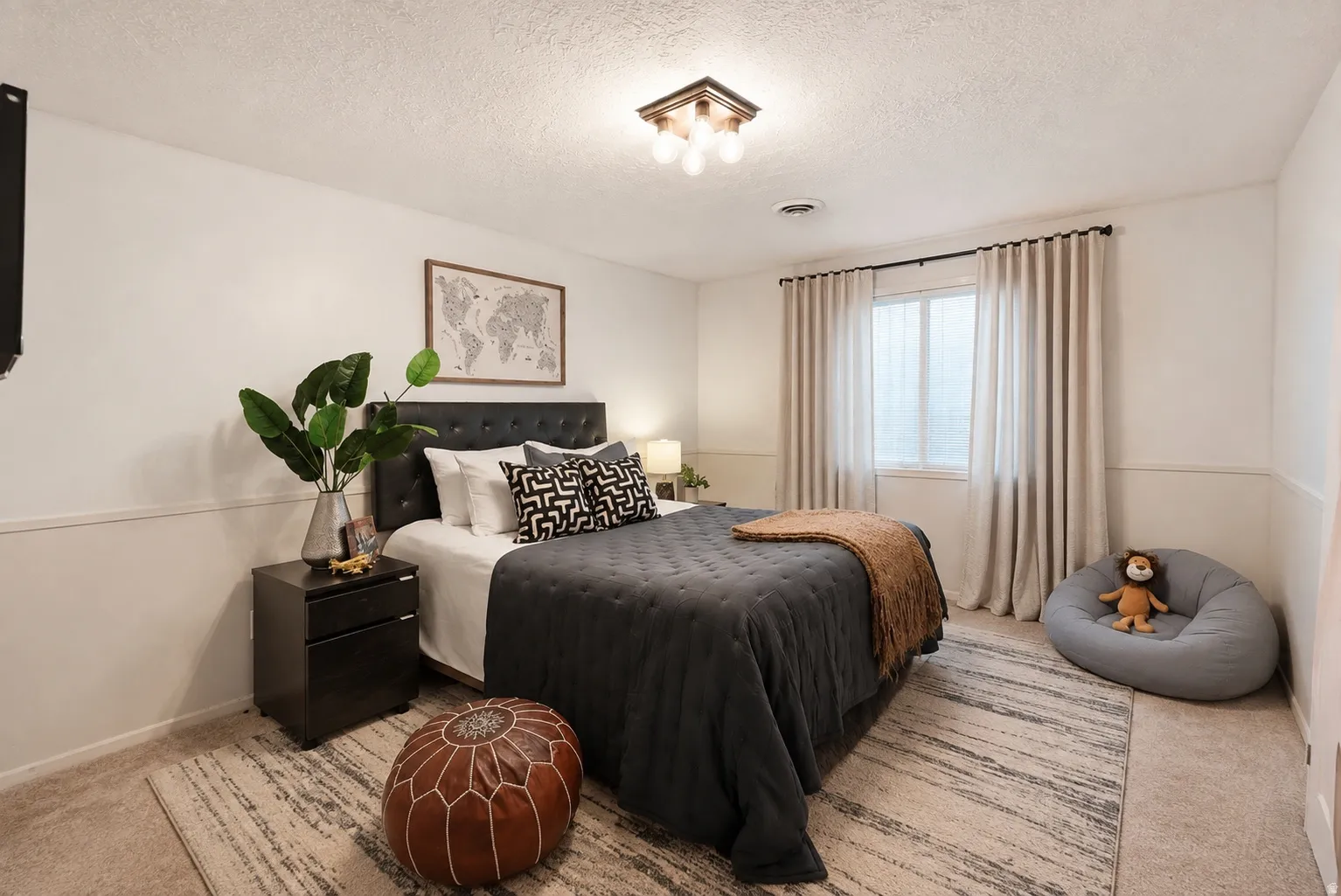 Recessed window with drapes, carpeted flooring, wall-mounted light fixture, and crown molding
