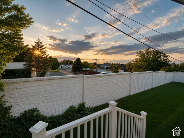 White painted brick perimeter wall with green lawn