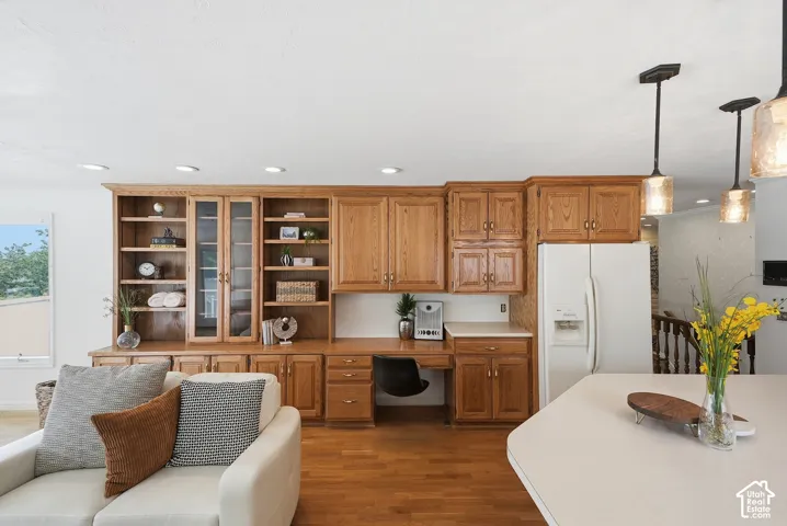 Built-in oak cabinetry and shelving with glass-front accents