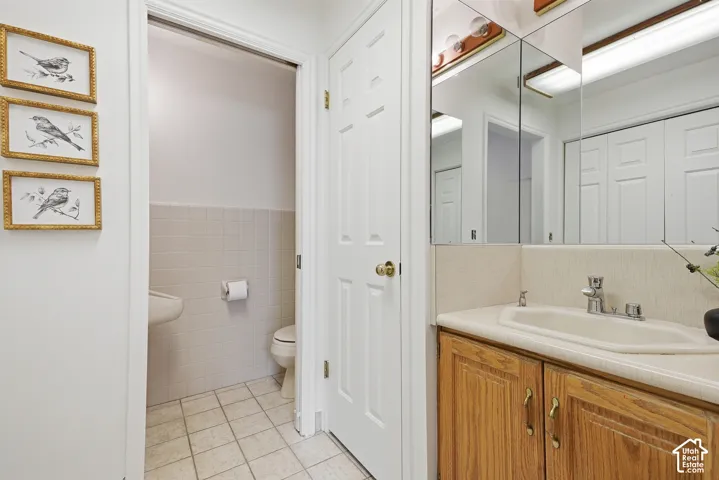 Vanity with wood-finish cabinetry, integrated sink, and mirrored medicine cabinet
