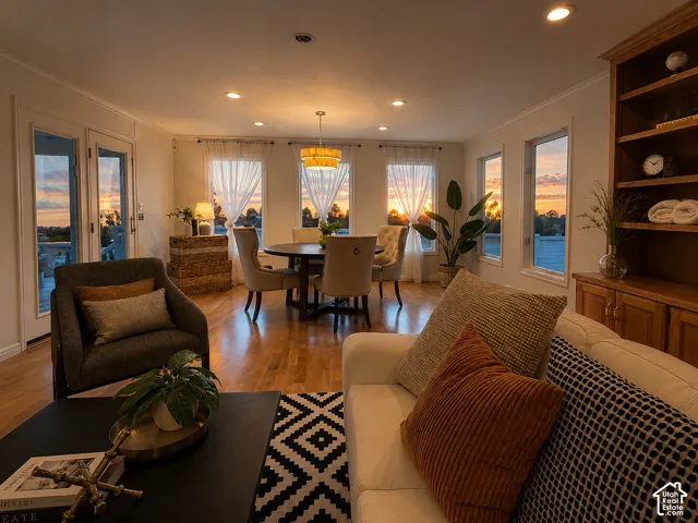 Wood-finish flooring, recessed lighting, and a built-in wood bookshelf with lower cabinetry