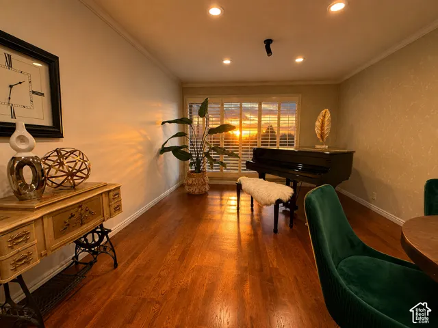 Hardwood flooring, recessed lighting, crown molding, and window shutters