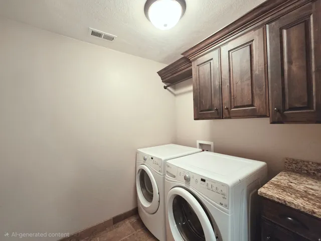 Laundry area featuring rich wood cabinetry, a hanging rod, a built-in countertop with a stone-finish surface, and tile flooring
