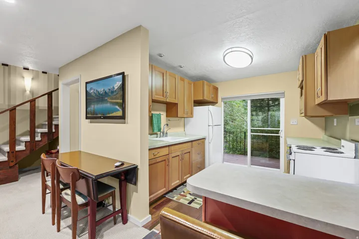 Kitchen featuring wood-finish cabinetry and included appliances