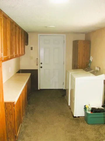 Built-in cabinetry with wood-finish doors and a light-toned countertop