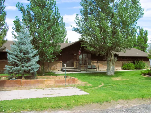 Brick exterior with dark trim and a gabled roof
