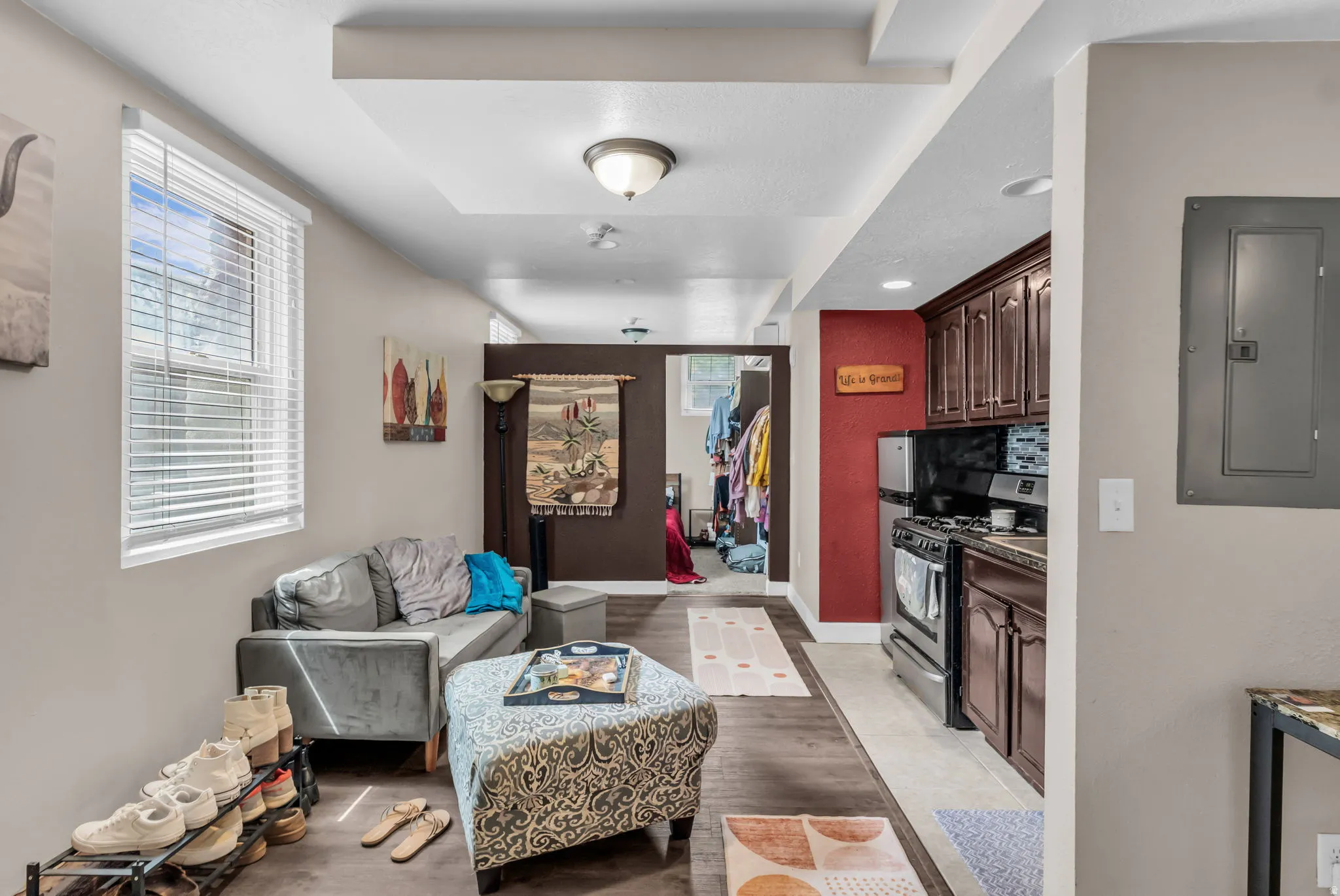 Recessed lighting, wood-finish flooring, and built-in kitchen cabinetry with a four-burner gas range