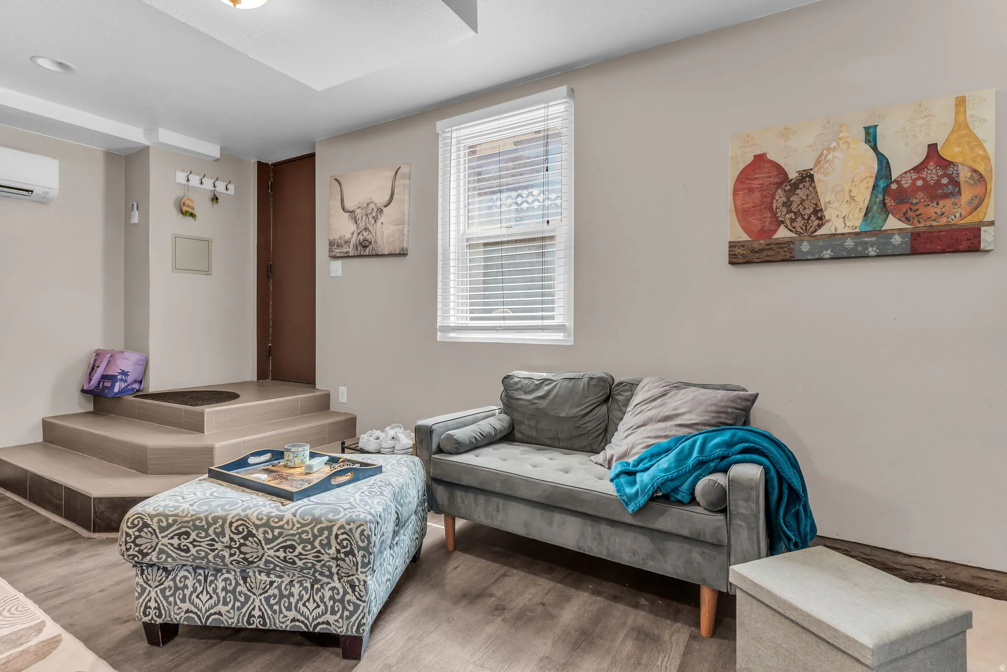 Wood-finish flooring with a multi-level entryway featuring built-in steps