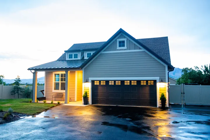 Modern farmhouse exterior with horizontal siding, a covered front porch, and a metal roof accent