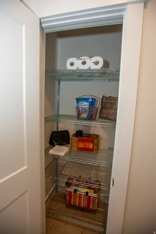 Adjustable wire shelving system within a built-in closet, featuring a white painted door and trim