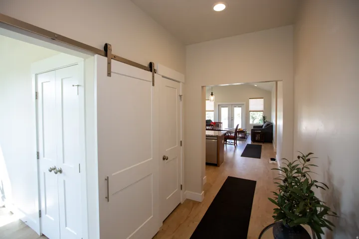 Wood-finish flooring, recessed lighting, and a barn door entry