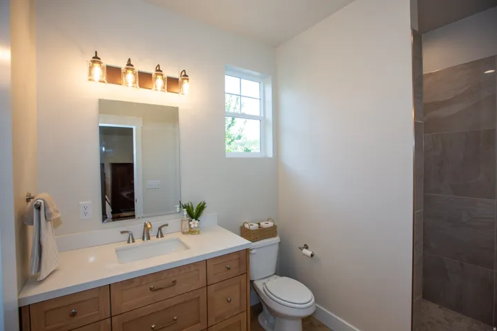 Primary Bath with vanity with wood-finish cabinetry, white countertop, and rectangular undermount sink