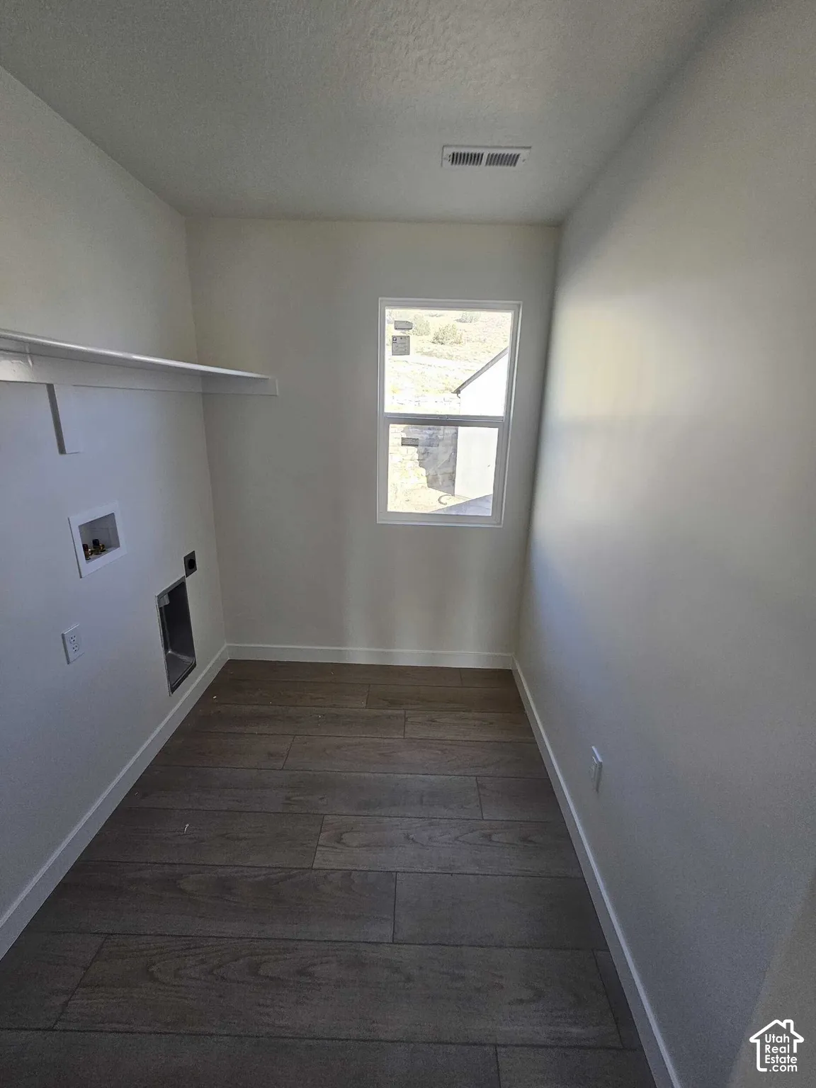 Wood-finish flooring with white baseboards