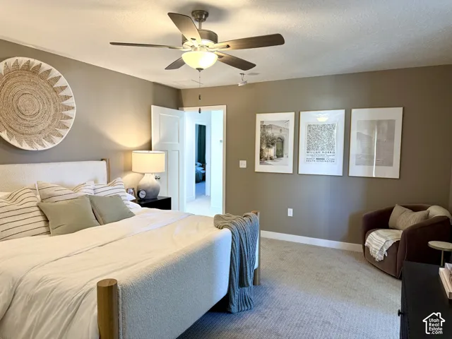 Recessed lighting, ceiling fan with integrated light fixture, carpet flooring, solid core interior doors, and warm neutral wall tones