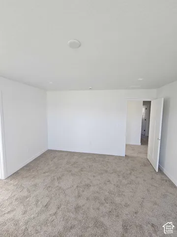 Recessed ceiling lighting and a neutral carpeted floor